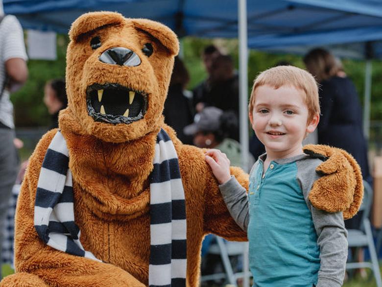 Child with Nittany Lion smiling 